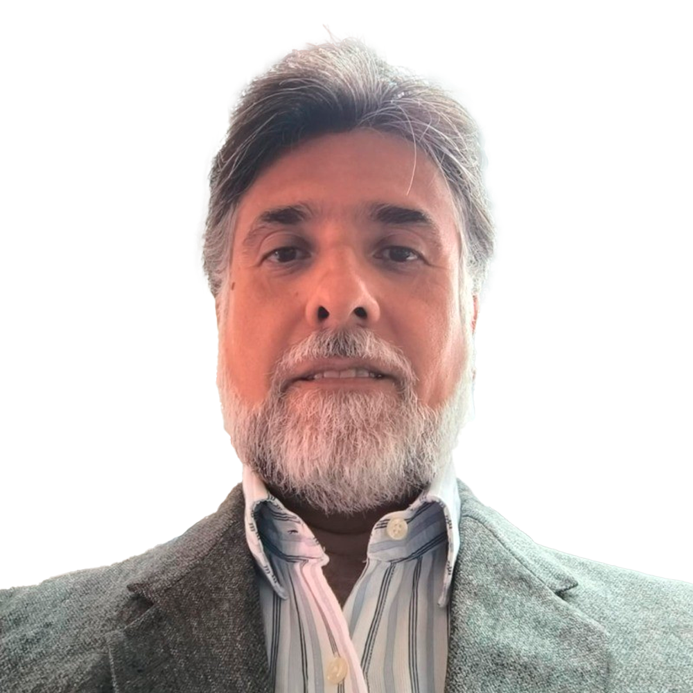 Profile picture of a person with short hair and a beard, wearing a black vest and white shirt, with a blurred outdoor background