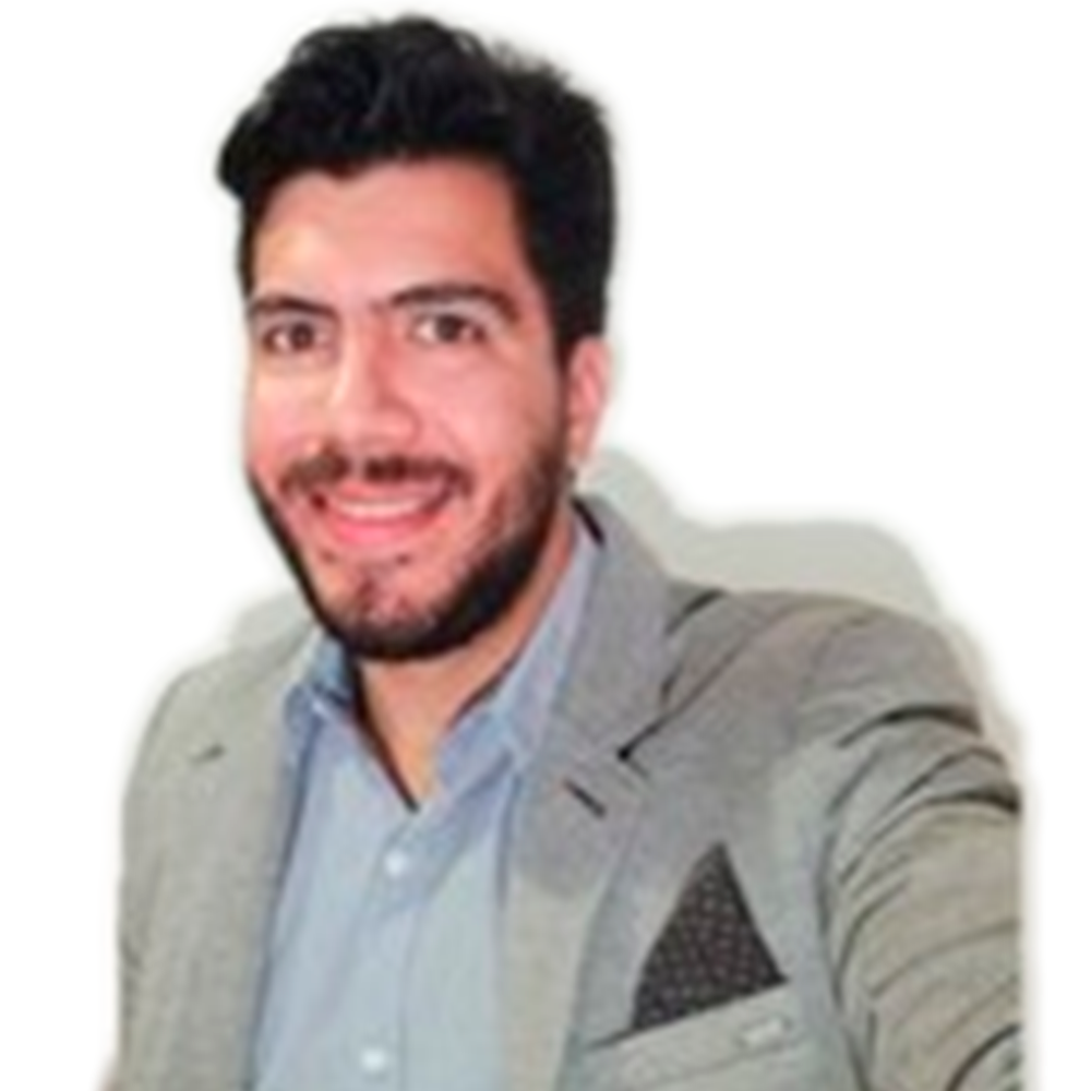 Profile picture of a person with short hair and a beard, wearing a black vest and white shirt, with a blurred outdoor background