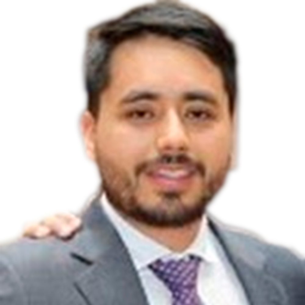 Profile picture of a person with short hair and a beard, wearing a black vest and white shirt, with a blurred outdoor background