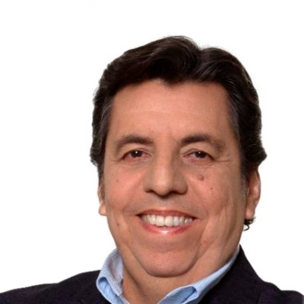 Profile picture of a person with short hair and a beard, wearing a black vest and white shirt, with a blurred outdoor background