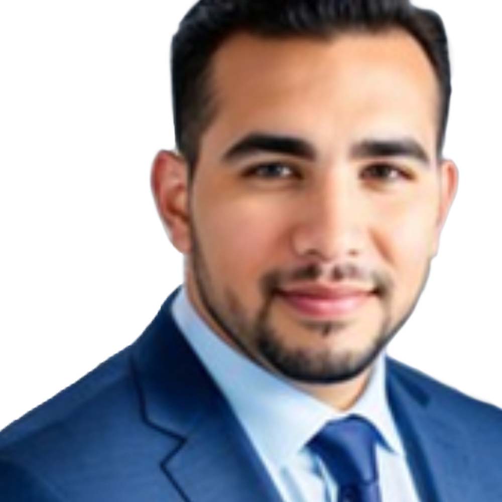 Profile picture of a person with short hair and a beard, wearing a black vest and white shirt, with a blurred outdoor background