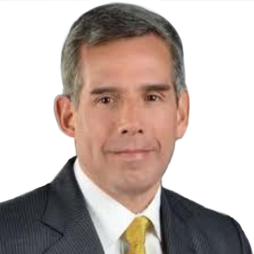 Profile picture of a person with short hair and a beard, wearing a black vest and white shirt, with a blurred outdoor background