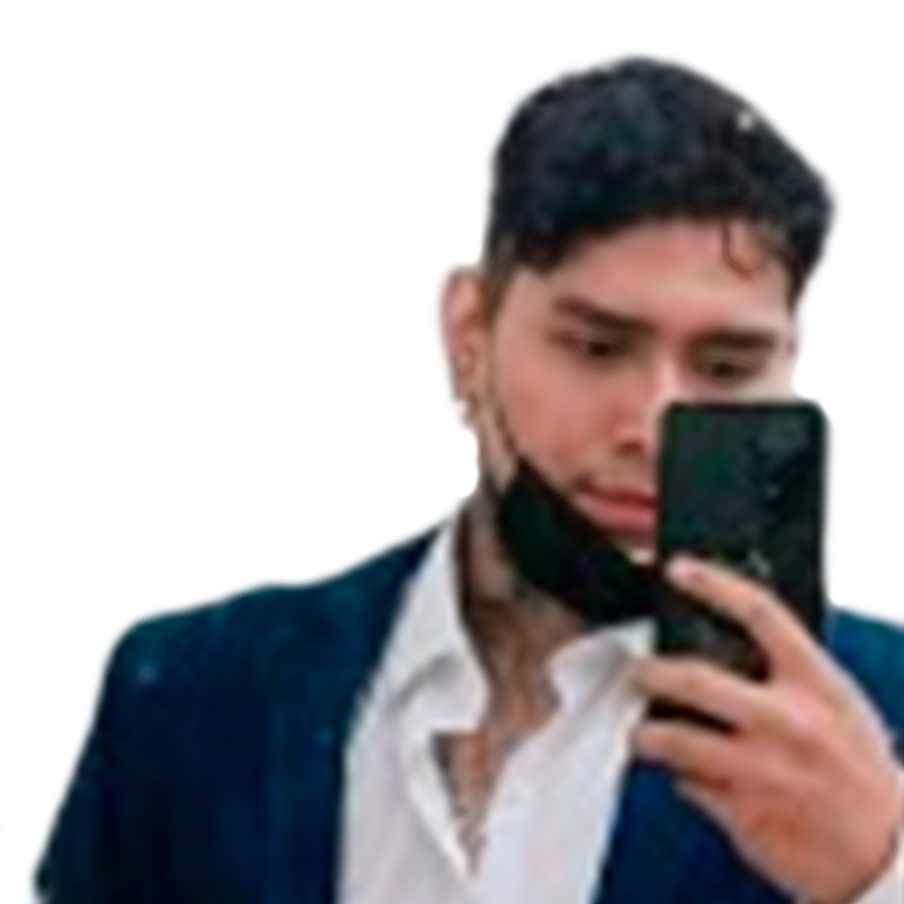 Profile picture of a person with short hair and a beard, wearing a black vest and white shirt, with a blurred outdoor background