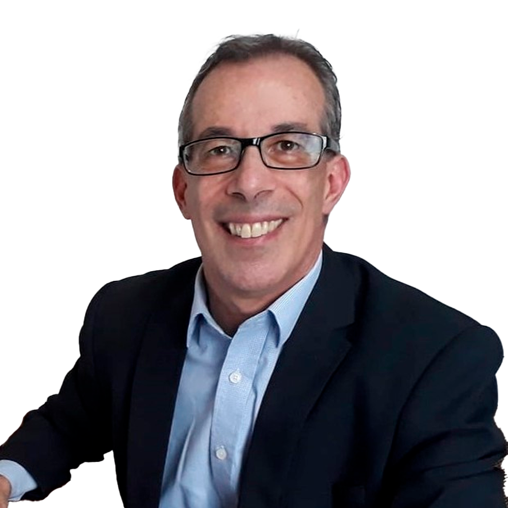 Profile picture of a person with short hair and a beard, wearing a black vest and white shirt, with a blurred outdoor background