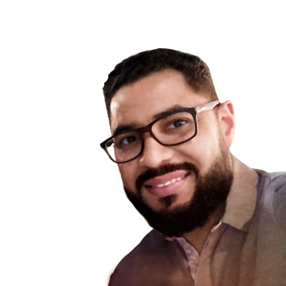 Profile picture of a person with short hair and a beard, wearing a black vest and white shirt, with a blurred outdoor background