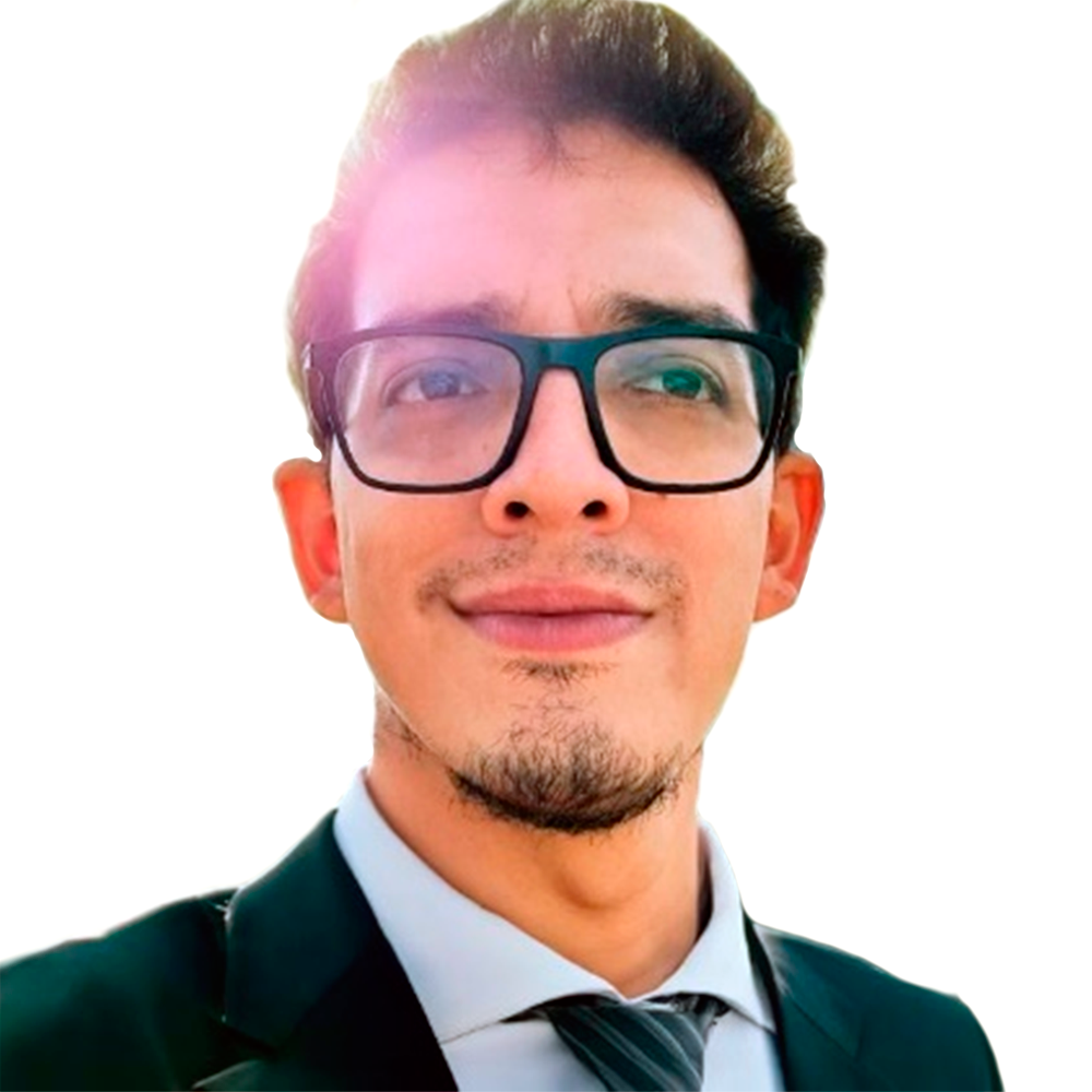 Profile picture of a person with short hair and a beard, wearing a black vest and white shirt, with a blurred outdoor background
