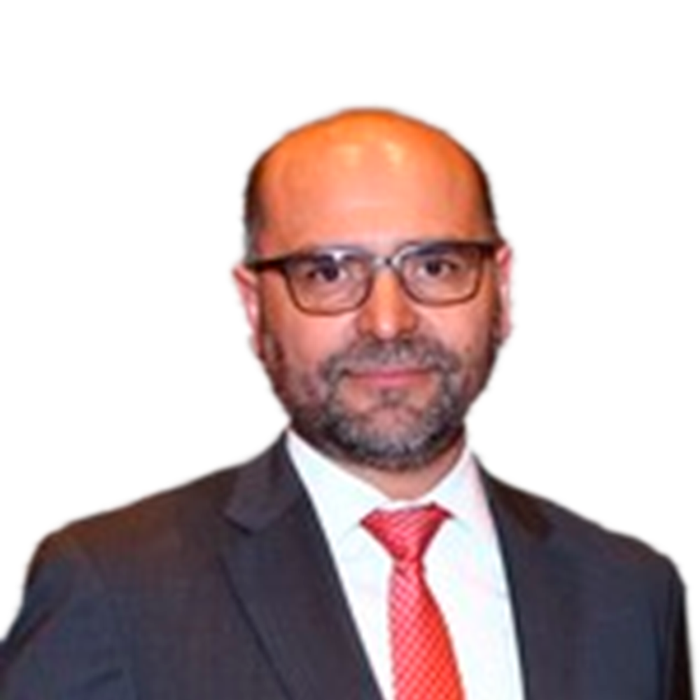 Profile picture of a person with short hair and a beard, wearing a black vest and white shirt, with a blurred outdoor background